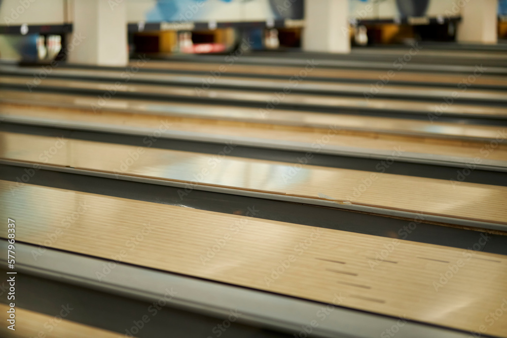 Bowling game in the sports center. many bowling alleys. Game in bowling club. Activities and entertainment. Bowling night. Soft focus. Bowling game in the sports center. many bowling alleys. Game in bowling club. Activities and entertainment. Bowling night. Soft focus.