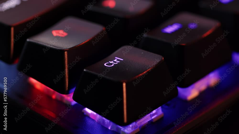 Human finger is clicking on the Ctrl button on the computer keyboard, close up view. The finger presses Ctrl on the keyboard key, macro shot. Loop footage.