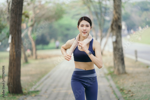 Asian women sprinting outdoors - Sportive people training, healthy lifestyle and sport concepts.