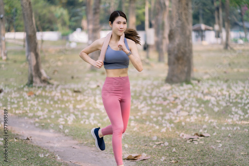 Asian women sprinting outdoors - Sportive people training, healthy lifestyle and sport concepts.