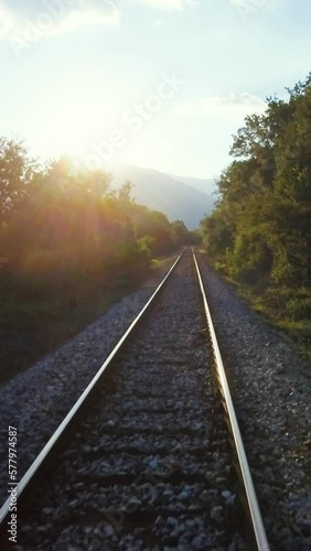 Sunny scenery, drone flying above railroad, vertical short video 