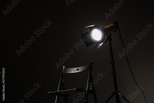 Movie directors chair on set with light on a stand. photo