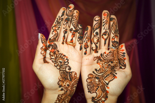 A Close up picture of a girl's hands decorated with aesthetically designed Mehndi or henna in Arabica style at a Hindu Wedding in Karnataka, India.
 photo