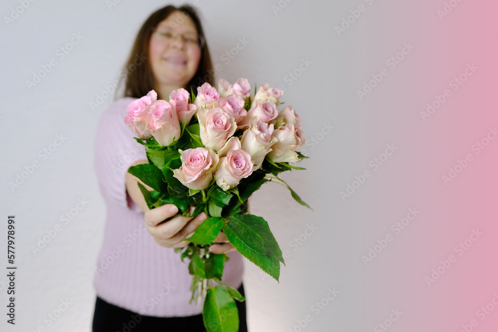 close-up of bouquet of white, pink roses, in hands of adult woman, brought flowers on date with girlfriend, boyfriend, gives to mom, concept of mother's, Valentine's day, birthday, christmas gift