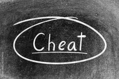 White chalk hand writing in word cheat and circle shape on blackboard background
