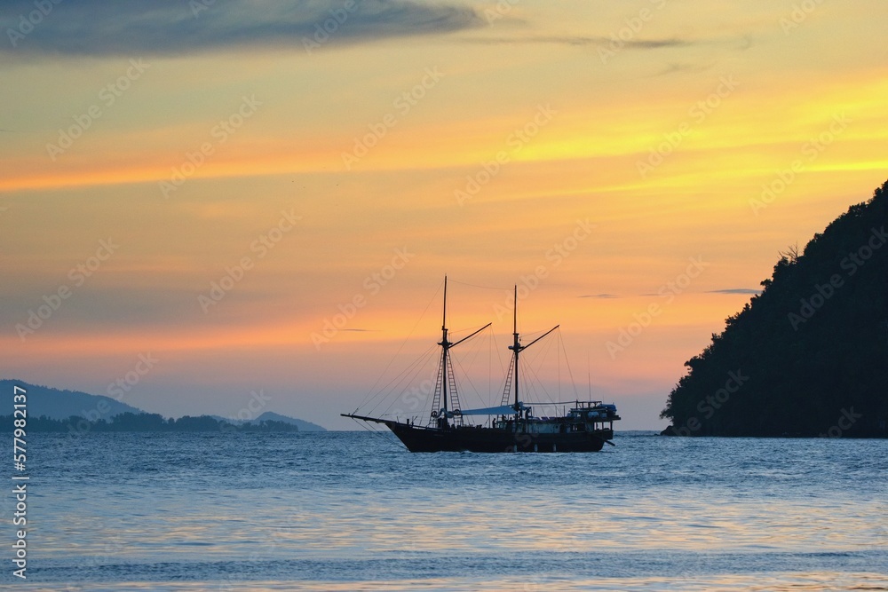 Yacht on the sea within a beautiful colorful sunset, Raja Ampat, West Papua, Indonesia