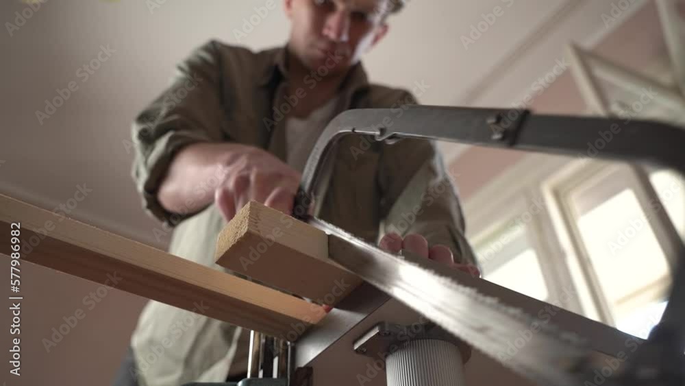 male craftsman works in a workshop with wood. sawing a plank. slow motion. male craftsman works in a workshop with wood. sawing a plank. slow motion.