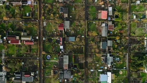 Allotment gardens in Germany from above. plots of different sizes with garden houses and holiday homes.