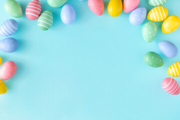 Easter background concept. Top view set of various colorful easter eggs on isolated pastel blue background with copy space