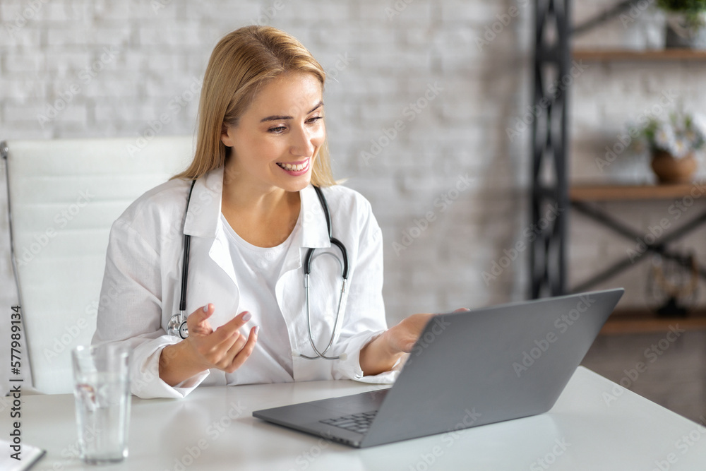 Woman doctor having online consultation with patient on a laptop sitting in the clinic office Woman doctor having online consultation with patient on a laptop sitting in the clinic office