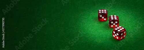 Three casino dice with winning numbers on green cloth, casino gambling, copy space.