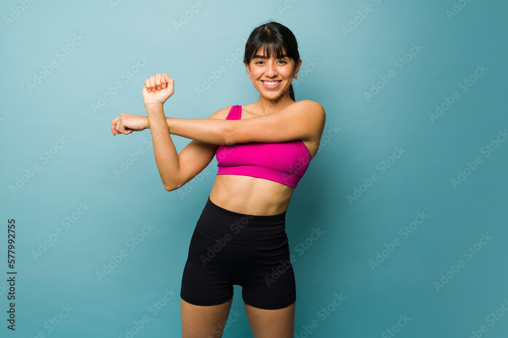 Cheerful beautiful woman warming up before a workout Cheerful beautiful woman warming up before a workout