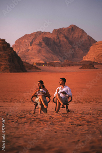 Wallpaper Mural Young Couple Sitting In The Wadi Rum Desert At Sunset With Cup Of Coffee, Jordan Torontodigital.ca