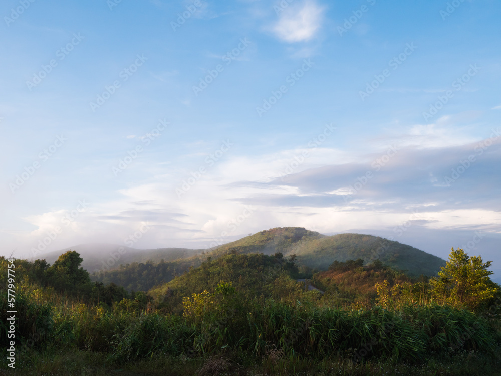 a scenic view of green mountains and fog at Thong Pha Phum National Park in Kanchanaburi, Thailand.