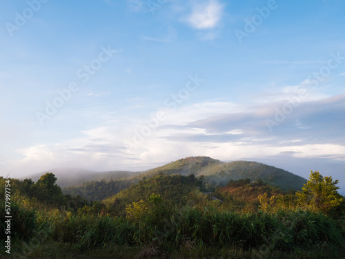 a scenic view of green mountains and fog at Thong Pha Phum National Park in Kanchanaburi, Thailand.