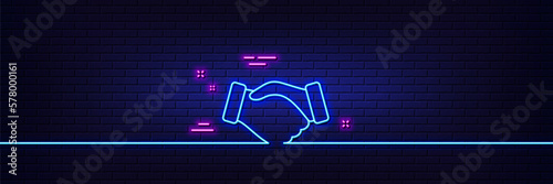 Neon light glow effect. Handshake line icon. Hand gesture sign. Business deal palm symbol. 3d line neon glow icon. Brick wall banner. Handshake outline. Vector