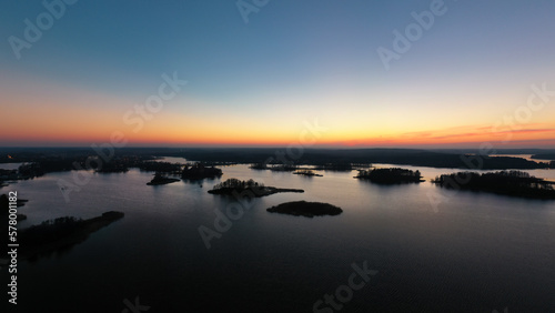 Sunset above tiny islands in the lake 
