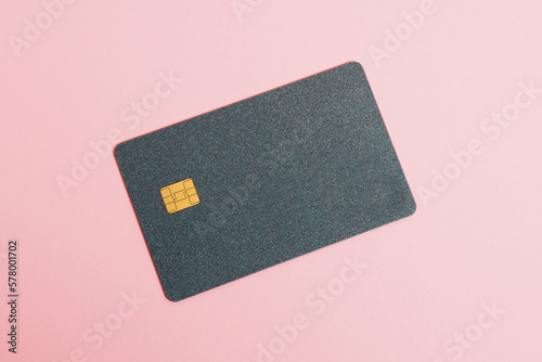 Bank card, credit card on a pink background with copy space, flatlay