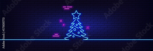 Neon light glow effect. Christmas tree present line icon. New year spruce sign. Fir-tree symbol. 3d line neon glow icon. Brick wall banner. Christmas tree outline. Vector
