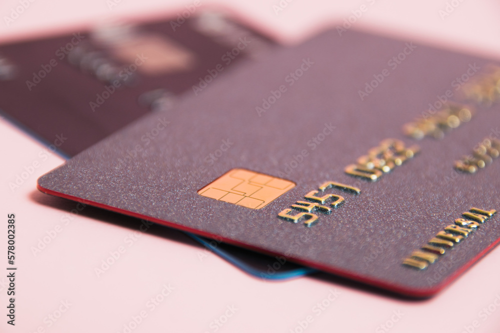 Bank cards with modern chips on a pink background. Protection of bank cards from fraudsters Bank cards with modern chips on a pink background. Protection of bank cards from fraudsters