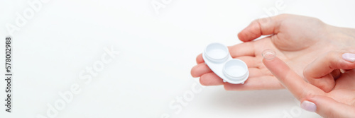 Contact Eye Lenses. Woman Hands Holding Contact Eye Lens. Woman Hands Holding White Eye lens Container. Beautiful Woman Fingers Holding Eye Lens Box. Health And Eye Care Concept. place for your text