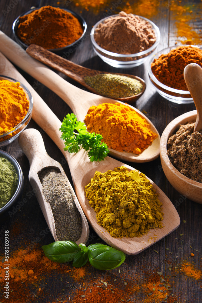 Variety of spices on wooden kitchen table. Variety of spices on wooden kitchen table.