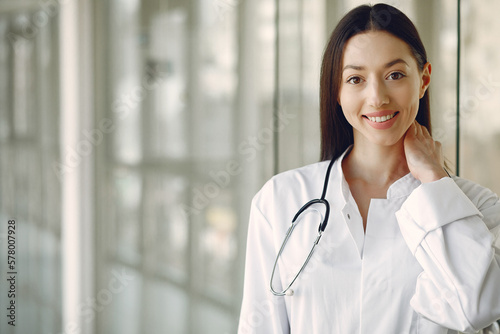 Woman doctor in a white uniforn standing in a hall