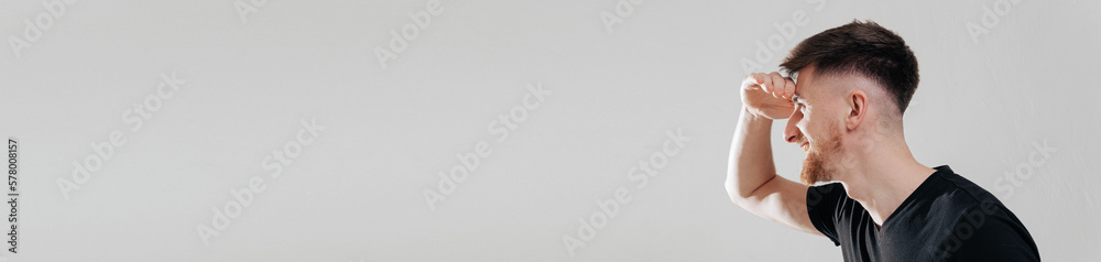 Obraz premium Profile portrait of young handsome man, guy with clean no acne face, one side, looks left and smiles happy and satisfied, standing against white background. banner