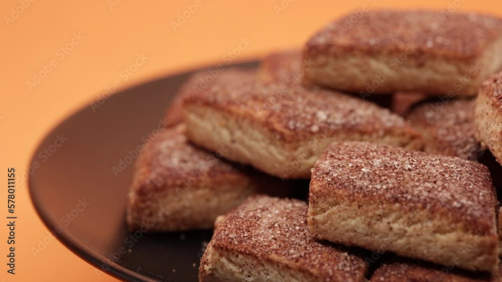 Fresh Cookies Rotating On Right Side. Sugar Biscuits In Black Plate. Food Concept On Orange Background. 4k, 60 FPS, ProRes