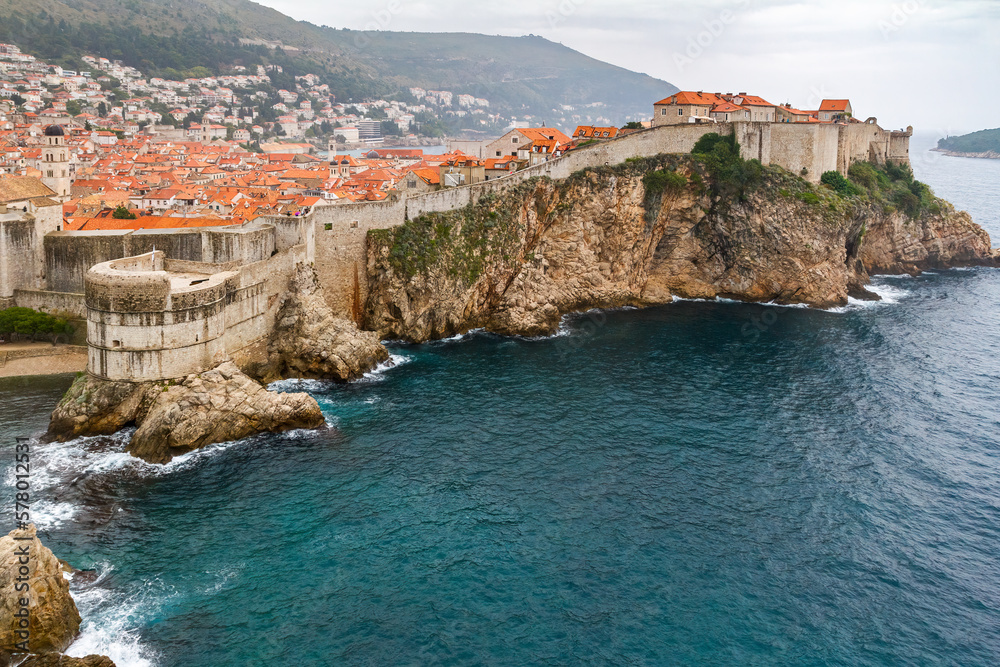 View of the Croatian city of Dubrovnik from the sea on a cloudy day.