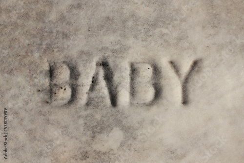 Baby written on a vintage tomb.