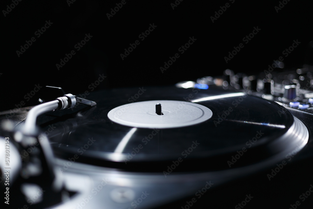 Retro style turntable plays vinyl record with music. Professional disc jockey turn table player device on stage. Retro style turntable plays vinyl record with music. Professional disc jockey turn table player device on stage.
