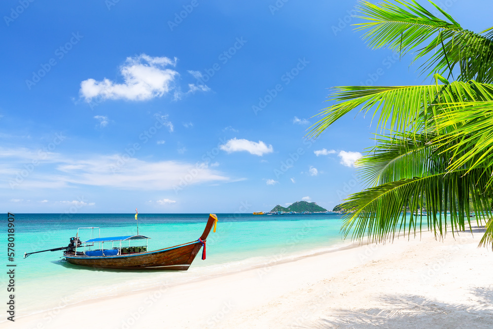 Palm tree and long tail boat on white sand tropical beach in Koh Tao island, Surat Thani Province, Thailand. Palm tree and long tail boat on white sand tropical beach in Koh Tao island, Surat Thani Province, Thailand.