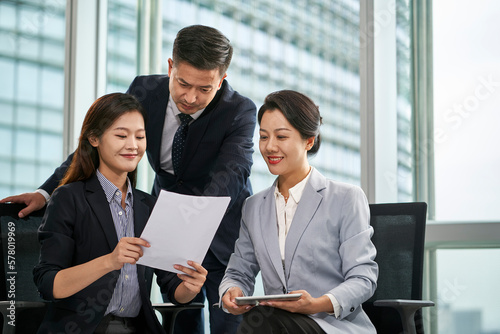 team asian corporate executives discussing business in office