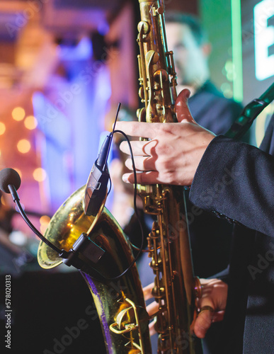 Photography Concert view of saxophonist, a golden saxophone, sax player with vocalist and mu