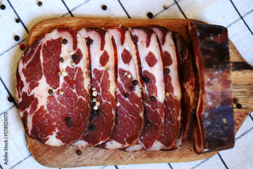 Capocollo. Italian ham slices on the board. photo