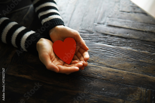 Hands of a woman holding and offering a heart shape. Love  health concept. Selective focus.Cinematic effect.