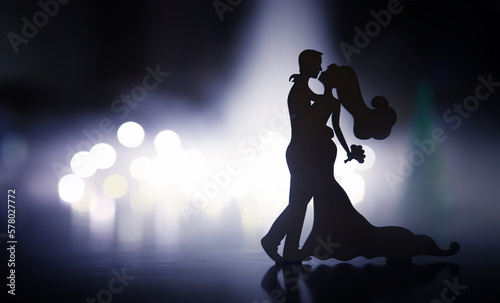 Black silhouettes of pair dancers performing. Man and woman are dancing with white backlight. Choreography. New Year's ball