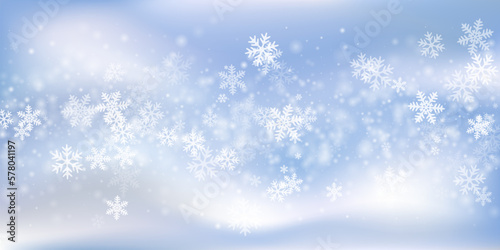 Fantasy flying snow flakes wallpaper. Wintertime dust frozen granules. Snowfall weather white blue composition. Blurred snowflakes december theme. Snow hurricane landscape. © SunwArt
