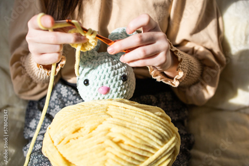 Hobby crochet. Person with knitting yarn. Woman knits soft toys. Amigurumi knitting technique. Hand with yarn