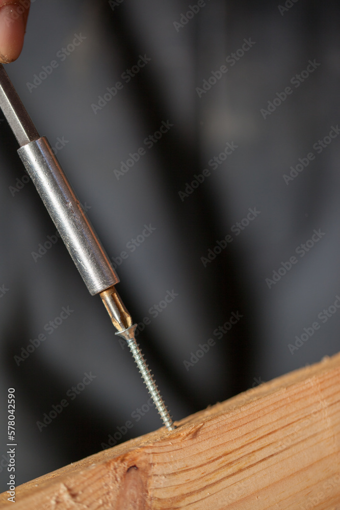 Fototapeta premium Carpenter using working tools while working on a wood in carpentry workshop