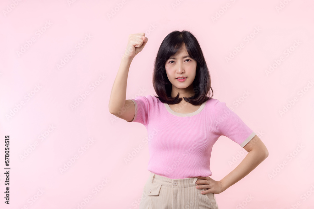 Portrait young asian woman proud and confident showing strong muscle strength arms flexed posing, feels about her success achievement. Women empowerment, equality, healthy strength and courage concept Portrait young asian woman proud and confident showing strong muscle strength arms flexed posing, feels about her success achievement. Women empowerment, equality, healthy strength and courage concept