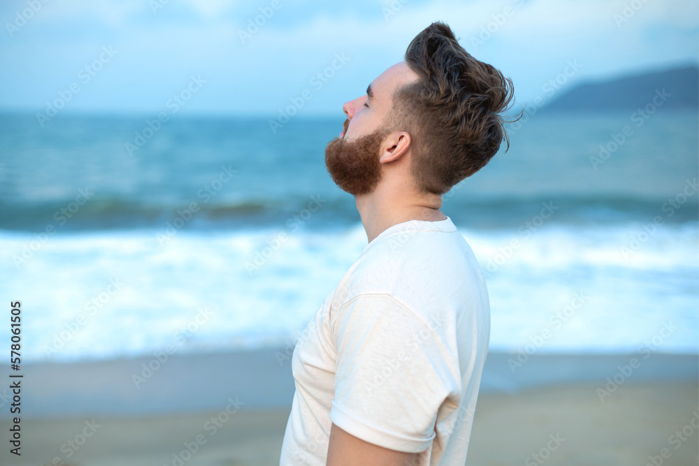 happy handsome free guy, young calm relaxed carefree man traveler enjoy sea on beach, ocean view, person feeling good, breath deep deeply fresh air. Freedom, travel, happiness concept, summer vacation happy handsome free guy, young calm relaxed carefree man traveler enjoy sea on beach, ocean view, person feeling good, breath deep deeply fresh air. Freedom, travel, happiness concept, summer vacation