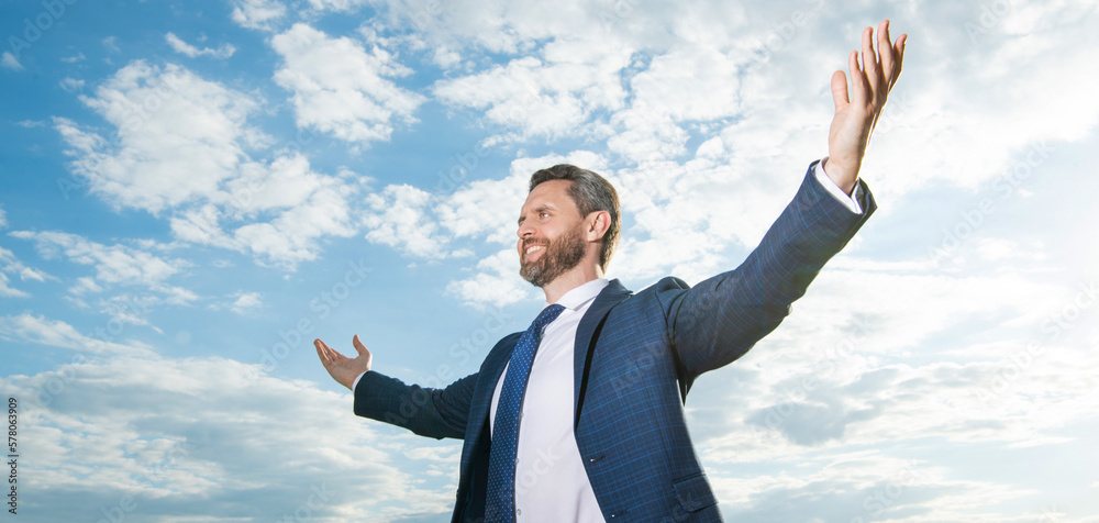 cheerful successful business man in suit on sky background. cheerful successful business man in suit on sky background.