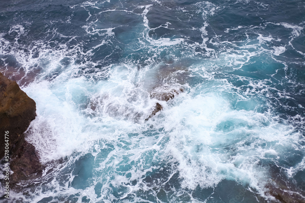 Waves in the ocean crash against the rocks