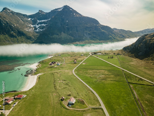 Aerial footage of Flakstad in Lofoten, Norway, during a sunny day with clouds photo