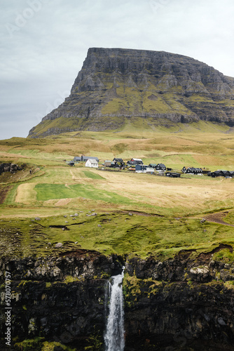 Country mountain landscape with a waterfall. Beautiful view of the Mulafossur Waterfall in the Faroe Islands (ID: 578070757)