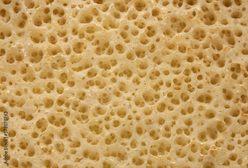 a close-up of a section of cheese with holes