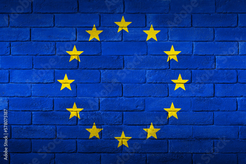 European Union flag painted on a brick wall.