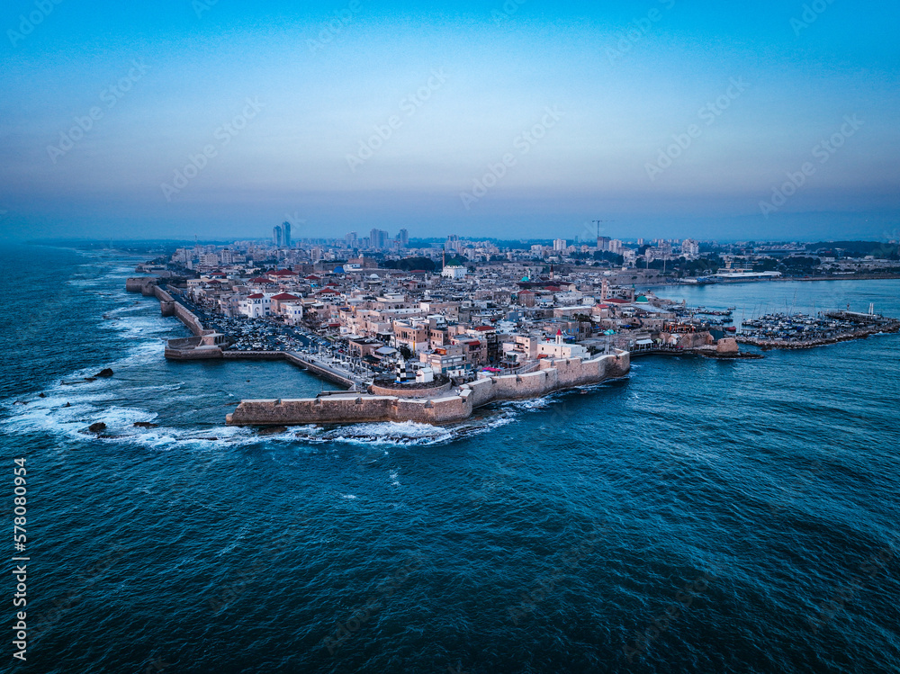 Acre (Akko) is a port city located on the Mediterranean coast and is known for its well-preserved ancient city fortifications. .Aerial footage of the old city, the ancient port and marina.